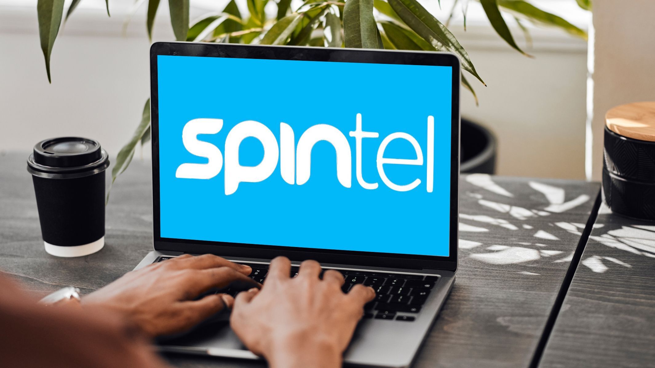 Laptop screen showing SpinTel logo