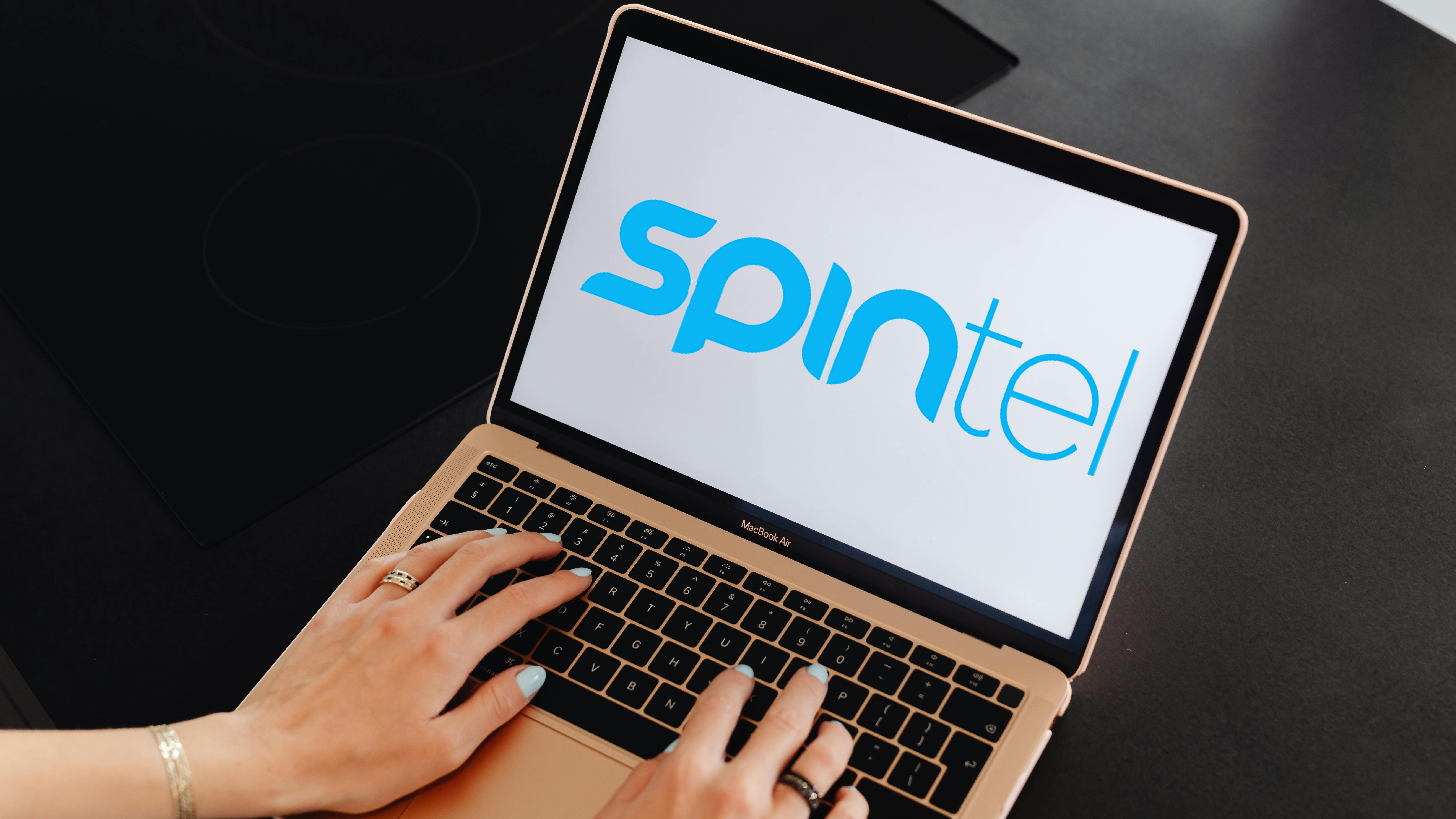 Laptop screen showing SpinTel logo