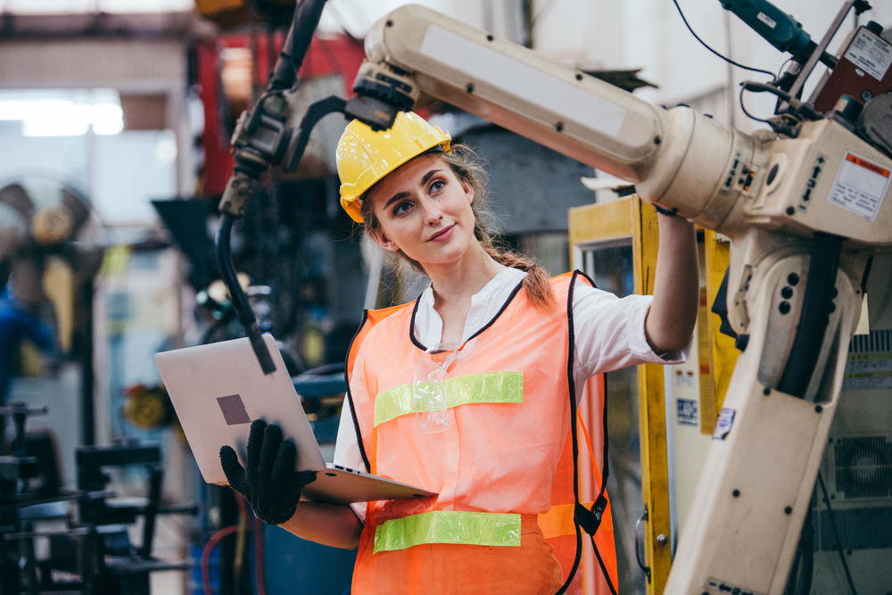 lady using heavy machinery in a high vis vest