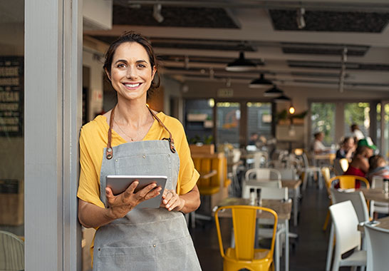waiter standing at the front door with a tablet