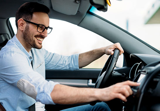 man driving a car touching the interface