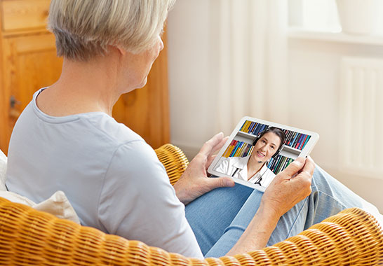 lady calling face to face with her doctor on a tablet 