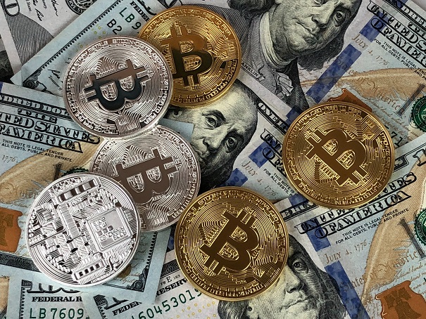Bitcoins on top of American bills