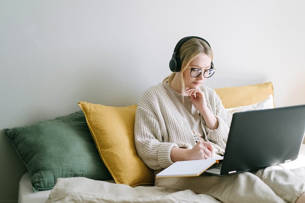 Woman on laptop taking notes